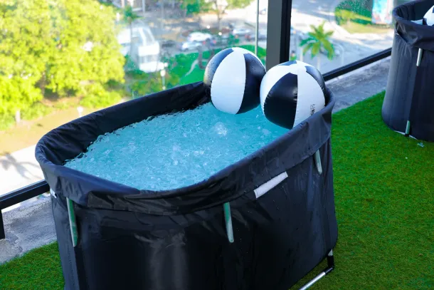 Cold plunge recovery tub with ice and beach balls on the rooftop of The Elser Hotel during Biohack Miami