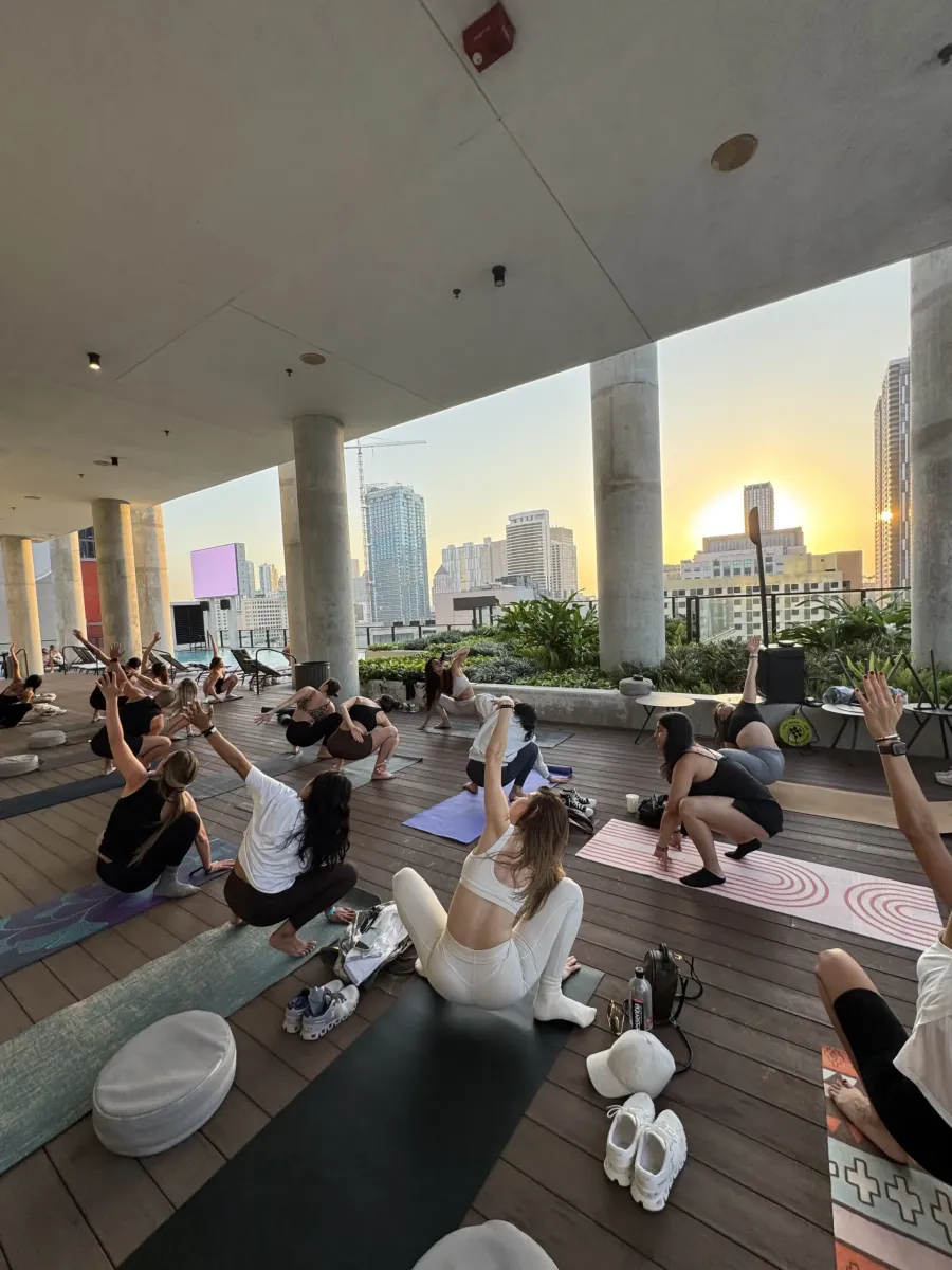 Sunset yoga class on the rooftop of The Elser Hotel during Biohack Miami with skyline views and a relaxing atmosphere