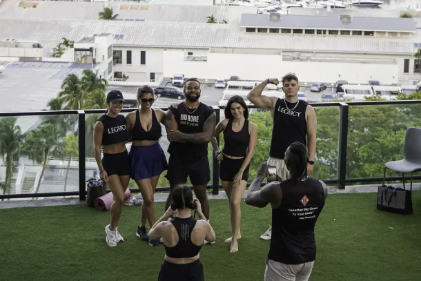 Fitness influencers and guests posing after rooftop workout at Biohack Miami, showcasing athletic community and urban wellness lifestyle